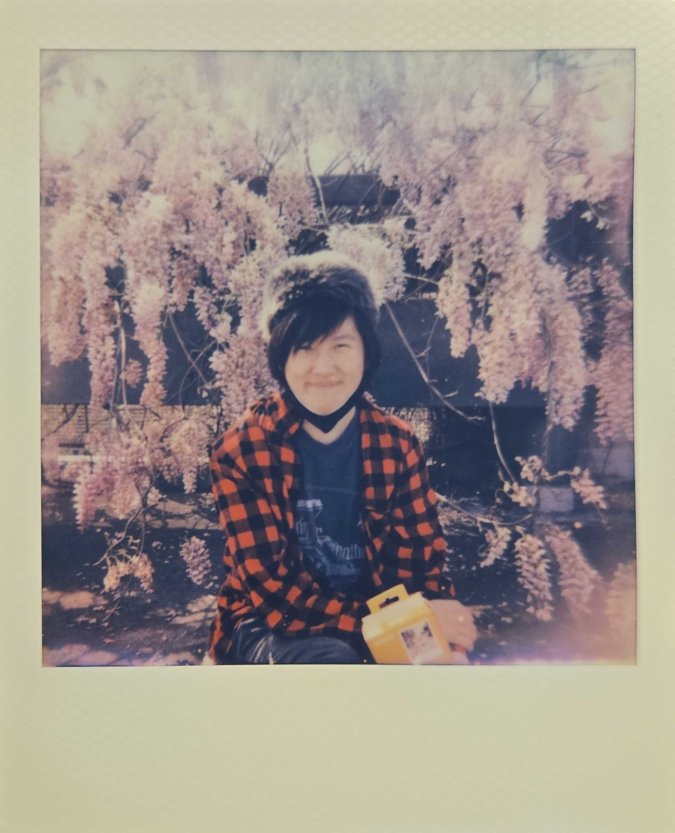 The developer, next to wisteria blossoms